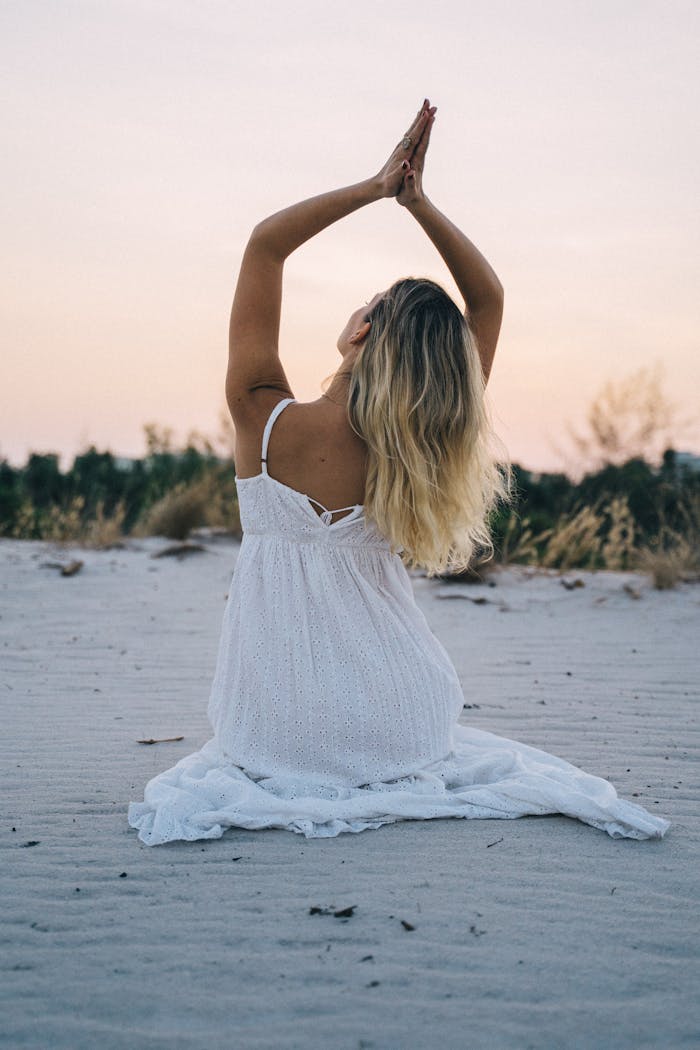 Woman in White Dress Sitting on Beach